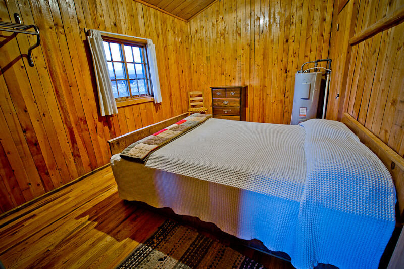 Wooden cabin with white bed