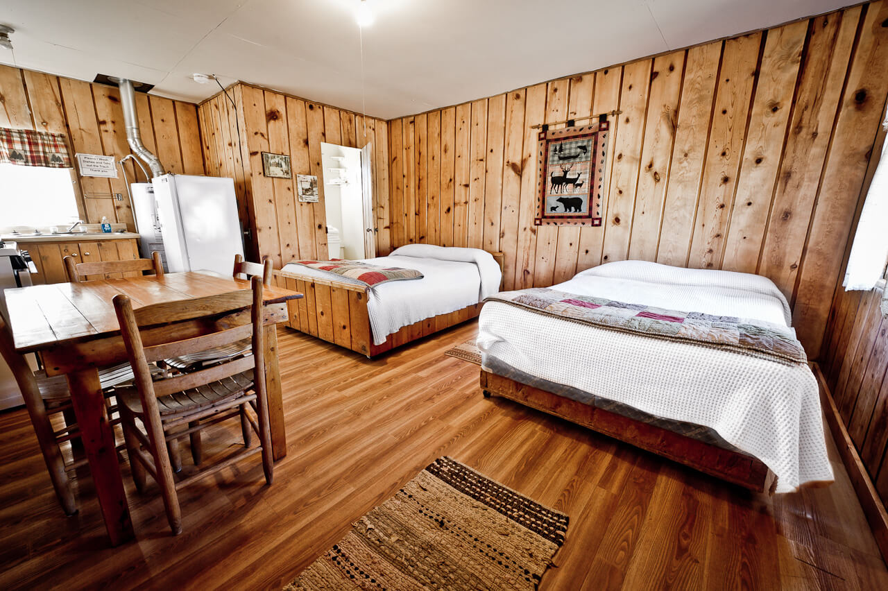 Wooden cabin with two white beds