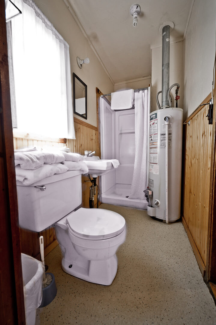 Bathroom with white walls and wooden paneling