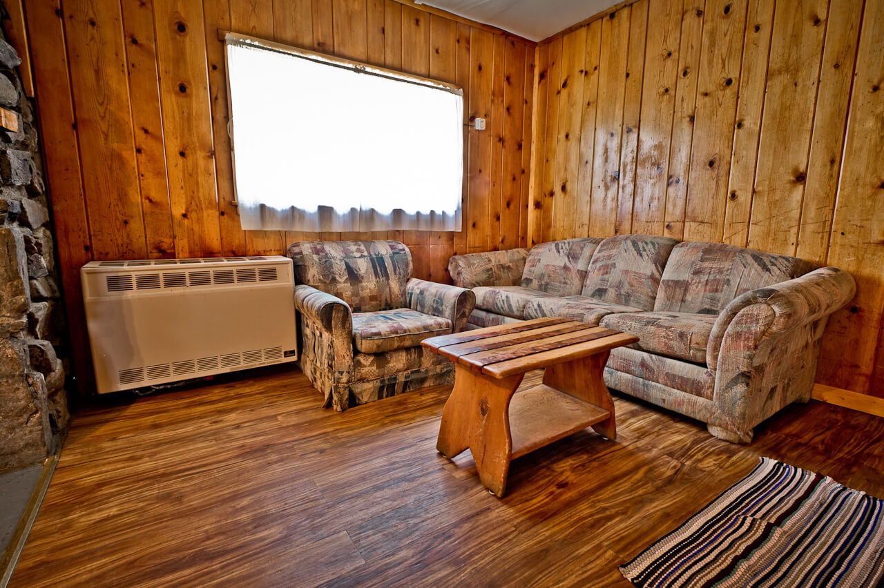 Wooden cabin lounge with two sofas