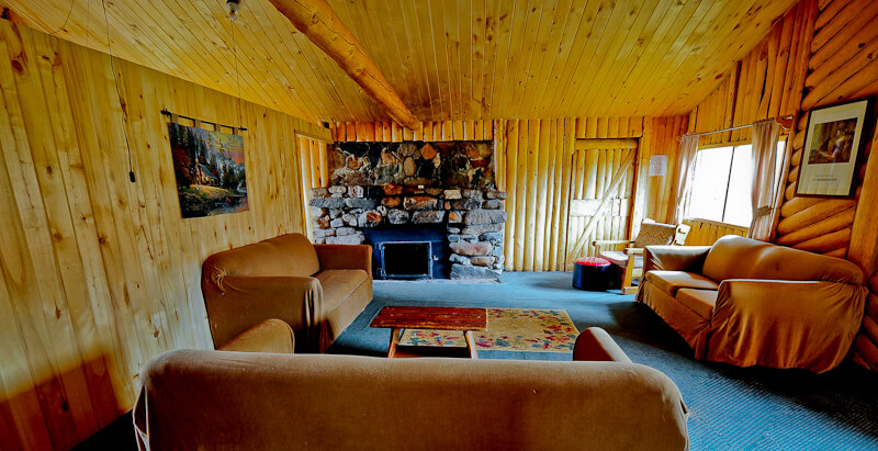Wooden cabin with brown sofas