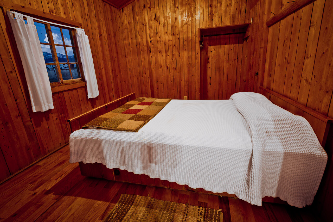 Wooden cabin with white bed