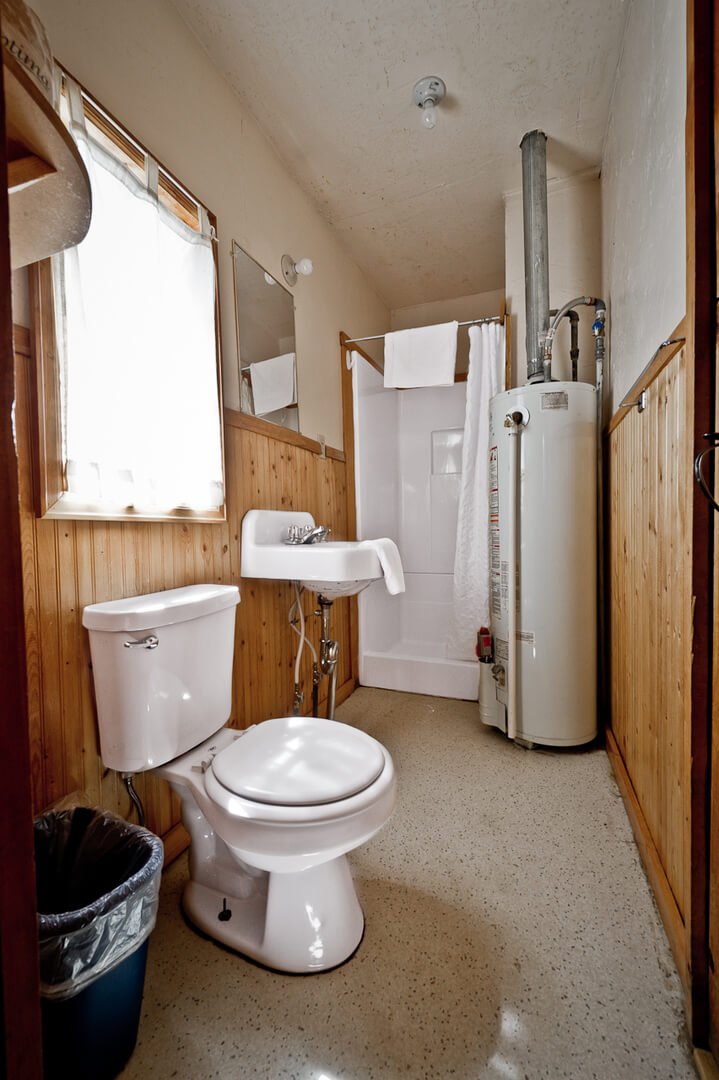 Bathroom with white walls and wooden paneling